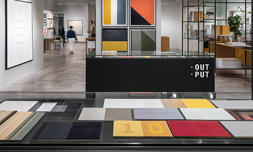 Exhibition counter with an OUTPUT sign and material samples